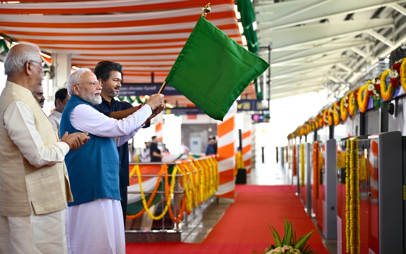 Prime Minister Narendra Modi waves a green flag to start the first train on the Poonamallee-Vadapalani stretch of Chennai Metro's Phase II in Tamil Nadu on Oct. 11, 2026.