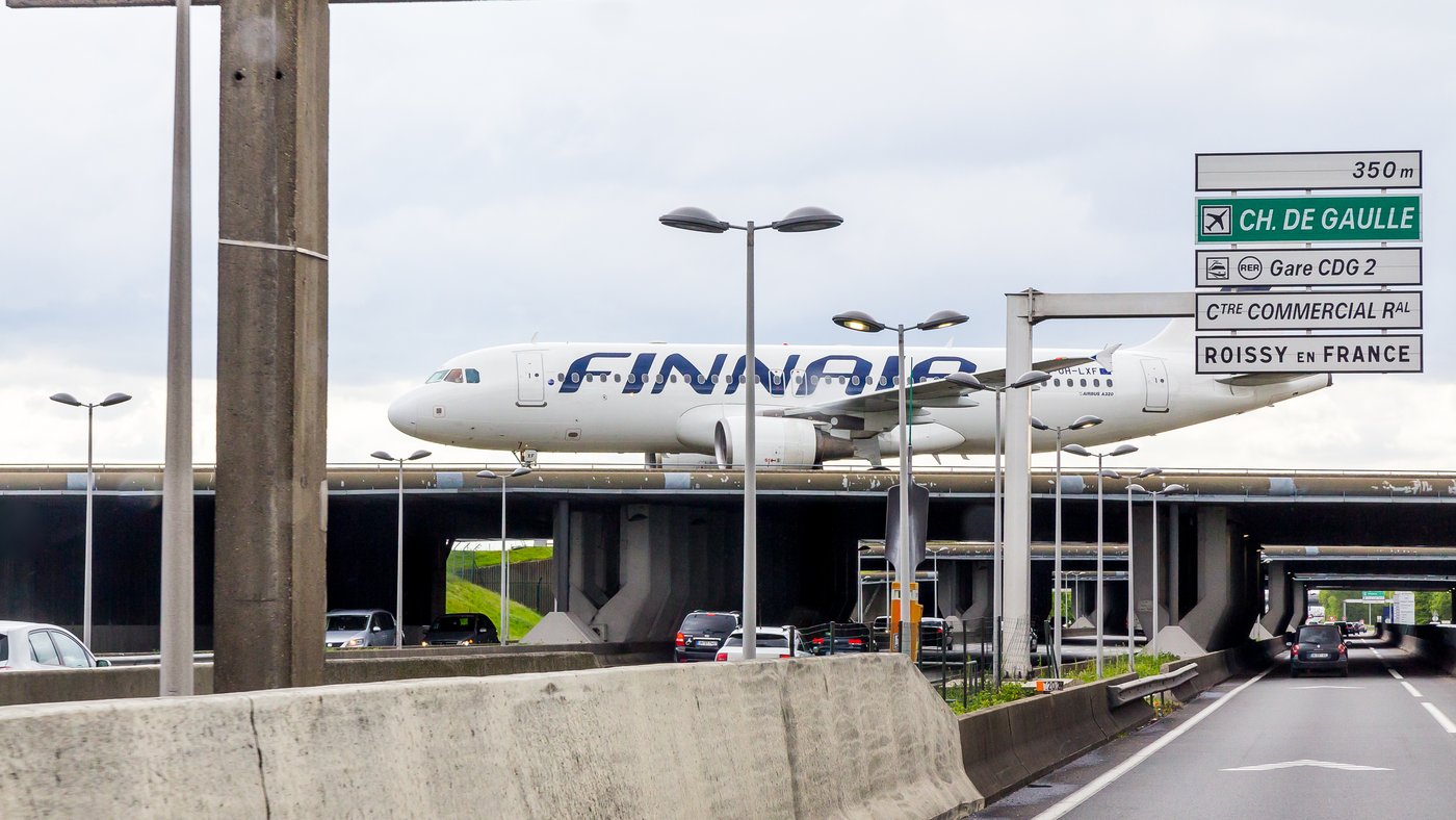 The A1 autoroute runs beneath a runway bridge at Paris-Charles de Gaulle Airport in 2017. The 1994 PROMETHEUS demonstration drives used the A1 near the airport.