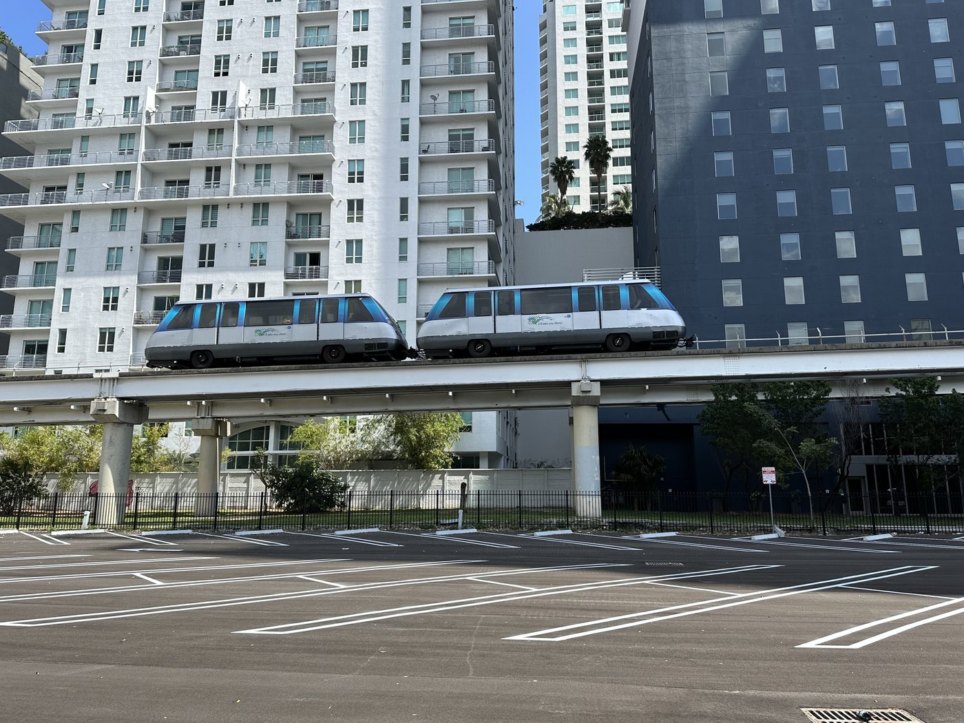 A two-car Metromover train on the elevated guideway in downtown Miami in March 2023.
