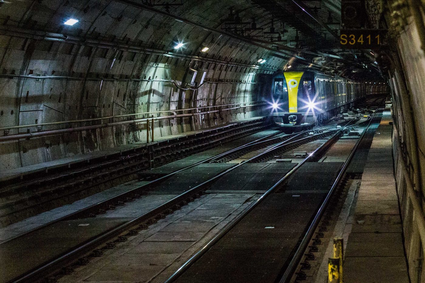A Line 4-Yellow train, its headlights on, runs through a tunnel of the São Paulo Metro in November 2014.