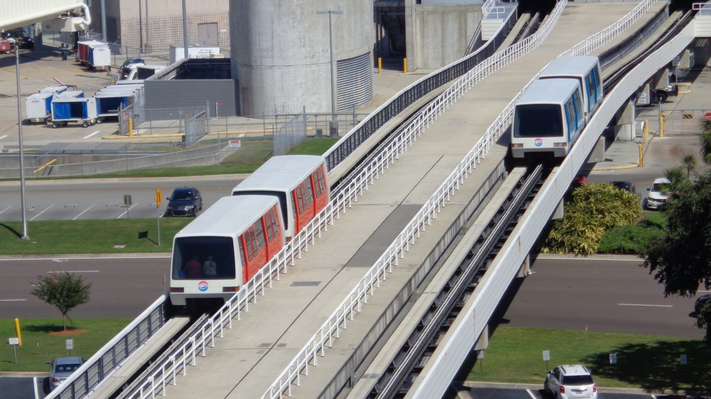 Red and blue automated shuttles on the elevated guideways to Airside C at Tampa International Airport in October 2018.