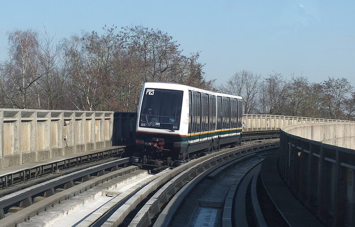 A Lille Metro VAL 208 automated train rounding an elevated curve.