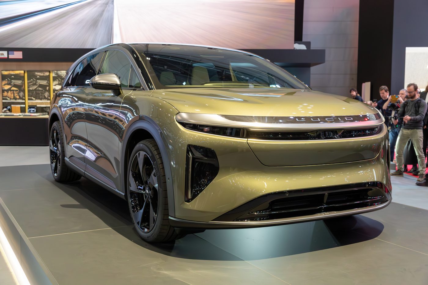 A Lucid Gravity SUV on a motor show stand.