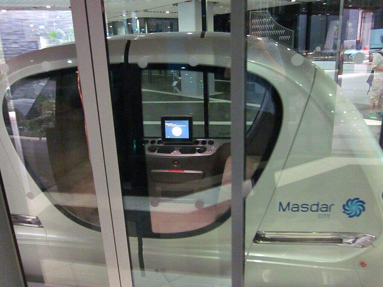 Interior of a Masdar City pod with a screen and no steering wheel.