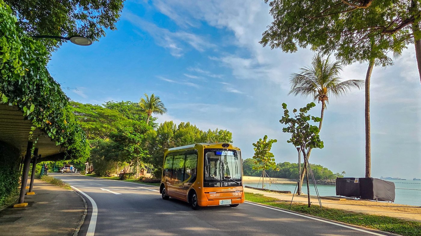 A self-driving shuttle using WeRide technology on a road beside the beach on Sentosa, Singapore.