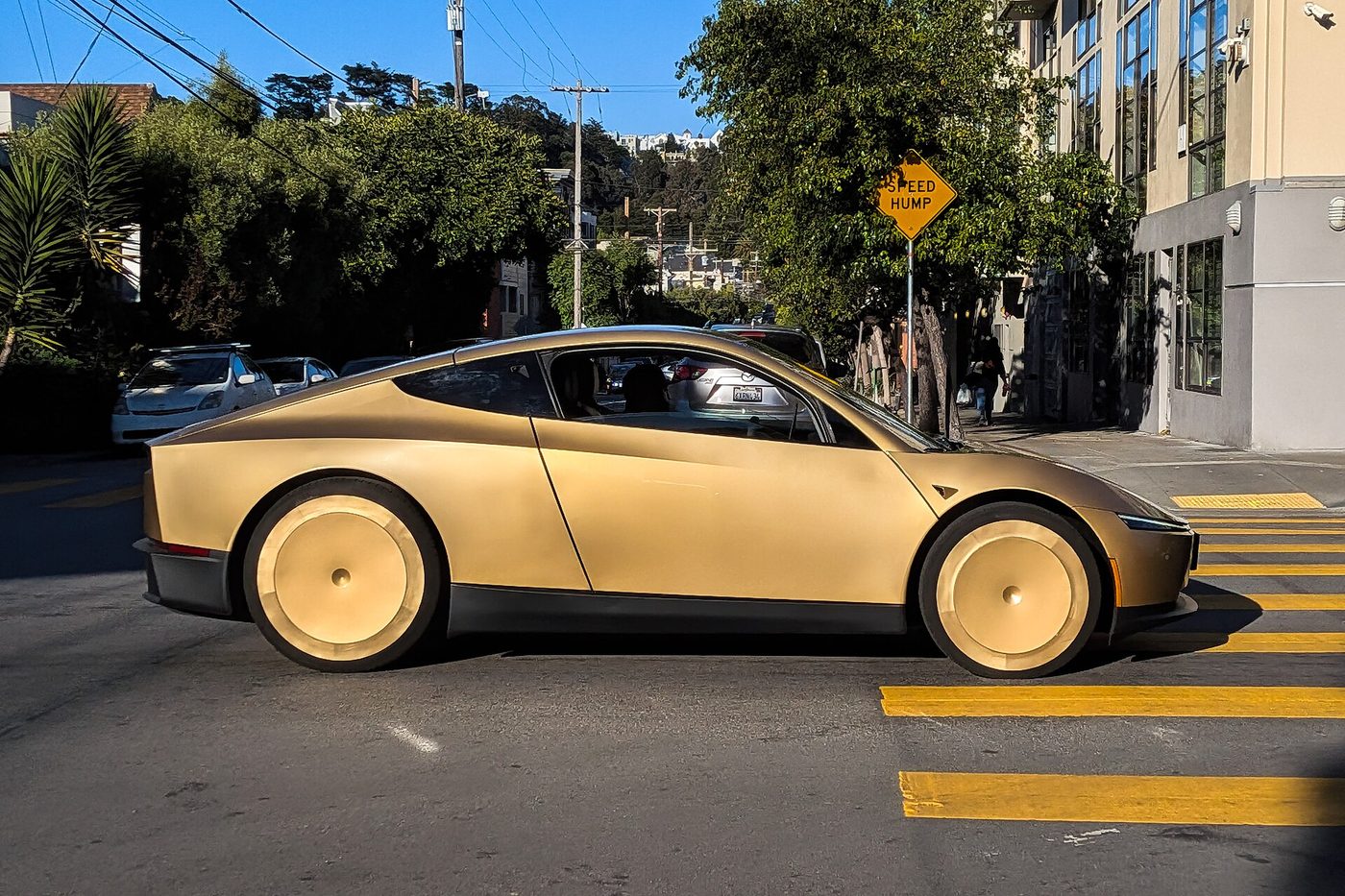 A gold Tesla Cybercab crosses a street in San Francisco in June 2026. File photo.