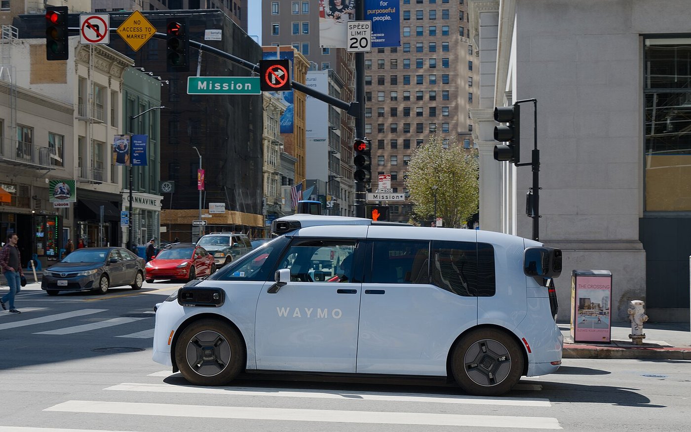 A Waymo Ojai robotaxi, the model Waymo runs in Las Vegas, crosses Mission Street in San Francisco in July 2026. File photo.