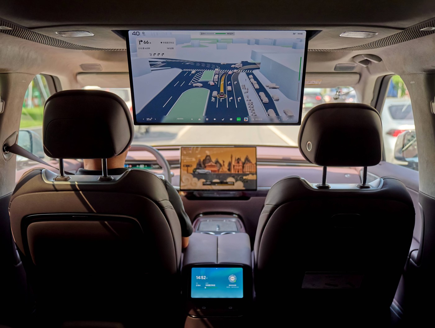 Cabin view of an XPENG robotaxi with the rear entertainment screen.